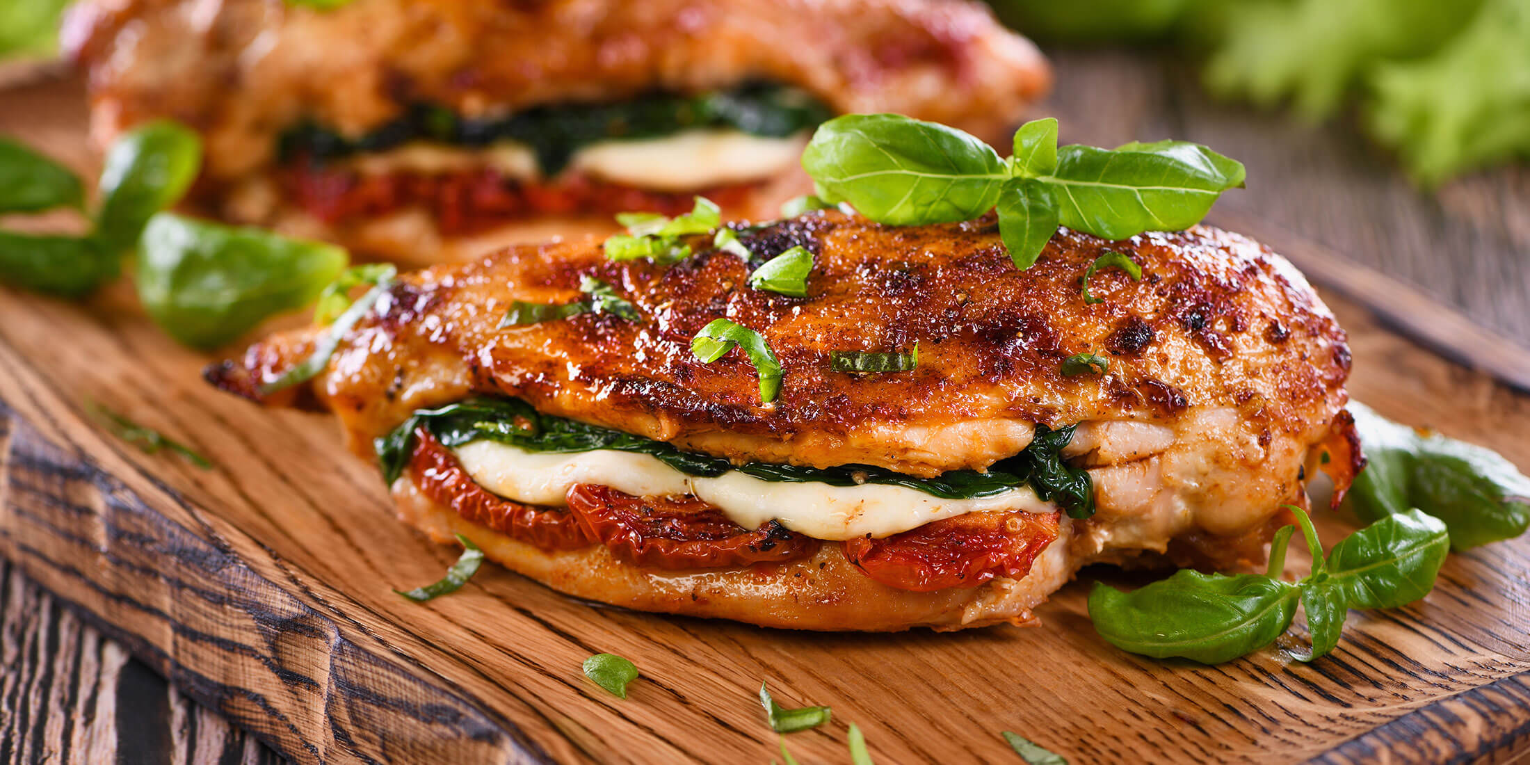 Stuffed chicken breasts on a cutting board